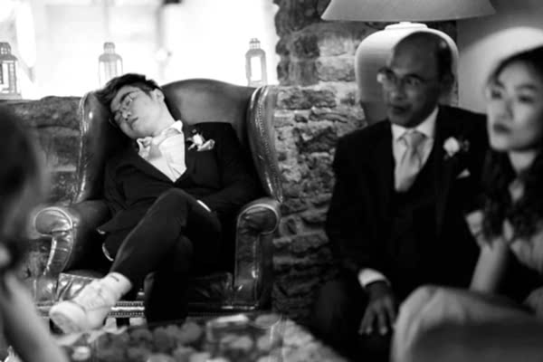 A man in a suit is peacefully sleeping in a chair at Dodford Manor.