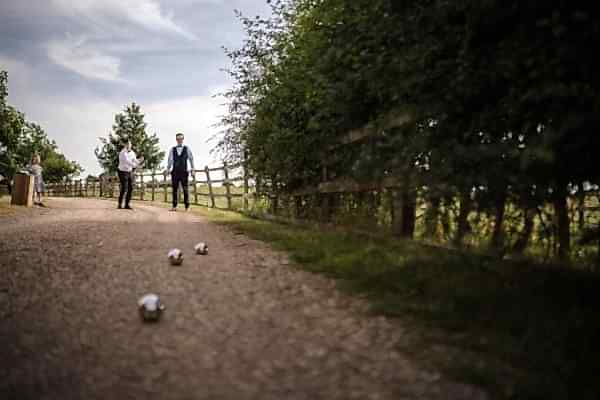 A group of men standing on a dirt path captured by a Dodford Manor wedding photographer.