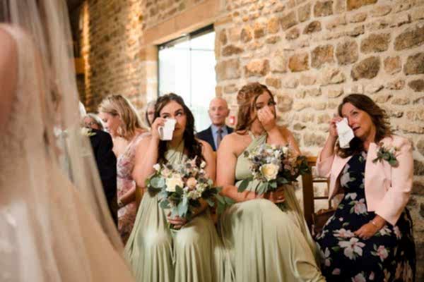 Dodford Manor Wedding Photographer captures the heartfelt moments of bridesmaids shedding tears of joy during the ceremony.
