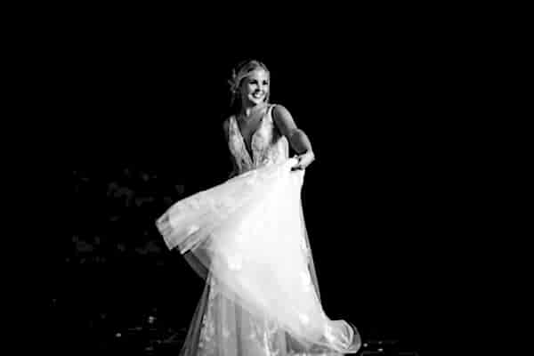 A black and white photo of a bride in a wedding dress, captured by a Dodford Manor Wedding Photographer.