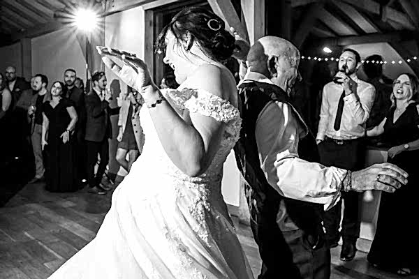 A bride and groom dancing at their wedding reception captured by the Dodford Manor Wedding Photographer.