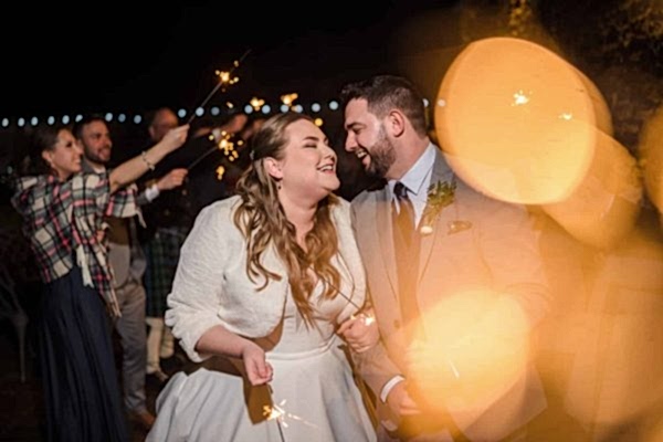 A bride and groom capture magical moments holding sparklers at their Dodford Manor wedding reception with the assistance of a skilled wedding photographer.