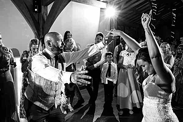 A Dodford Manor wedding photographer captures the magical moment of a bride and groom dancing at their reception.