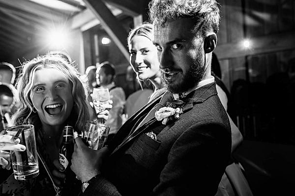 Dodford Manor Wedding Photographer captures a timeless black and white photo of a group of people at a wedding.