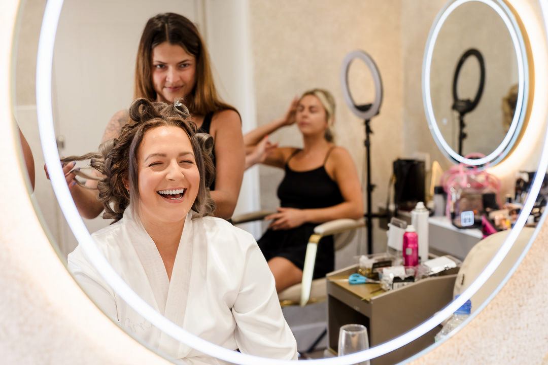 Woman laughing during hair and makeup session